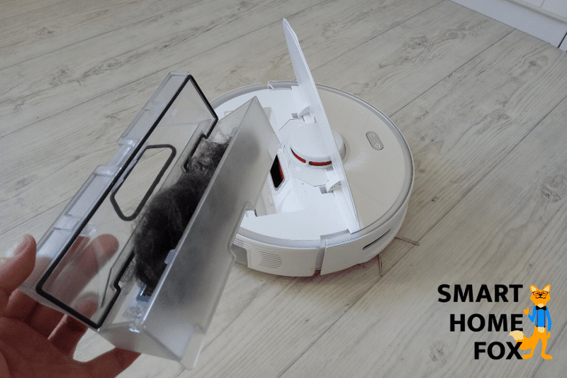Mobile dust bin of a robotic vacuum cleaner filled to the brim with pet hair.